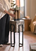 Luxury modern marble planter stand with black metal legs holding gold textured vases